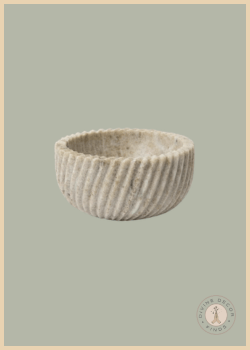 Beige Spiral Marble Bowl by McGee & Co. featuring a sculptural spiral design and natural marble texture on a soft sage background.