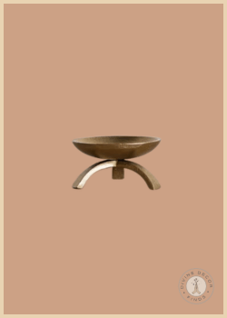 Brass Inspired Tripod Pillar Candle Holder featuring a sculptural tripod base and warm brass finish, styled against a warm neutral background.