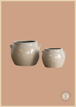 Ceramic Crock Planters in two sizes featuring a glossy glazed finish, decorative side handles, and a vintage-inspired design, styled against a warm neutral background.