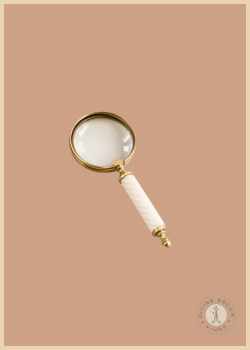 Cream Resin Magnifying Glass featuring a classic brass-finished lens and elegant cream resin handle, styled against a warm neutral background.