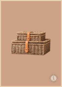 Simple Treasures Woven Boxes Set featuring two handwoven natural fiber storage boxes with leather-style strap closures and antique brass hardware, styled against a warm neutral background.