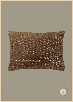 Crate & Barrel Sashiko chocolate brown velvet lumbar pillow with hand-embroidered ivory stitching in geometric patterns.