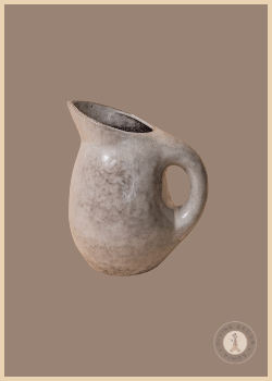 Bone-colored Archie Pitcher from Shoppe at The Avenue with a rounded stoneware body, curved handle, and reactive glaze.